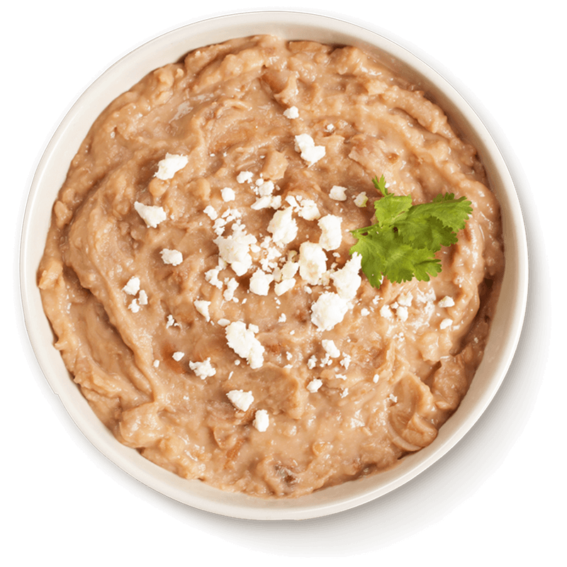 Bowl of refried beans topped with fresh cheese and cilantro