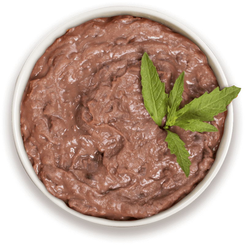 Bowl of black refried beans garnished with herbs