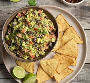 Guacamole with whole black beans and tortilla chips